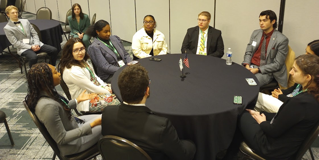 A group of youth sitting around a table.